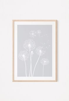 a dandelion print hanging on a wall