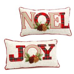 two christmas pillows that say noel and joy with pine cones on the bottom one is red and white