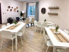 an empty room with tables and chairs set up for a meeting or social gathering in the center