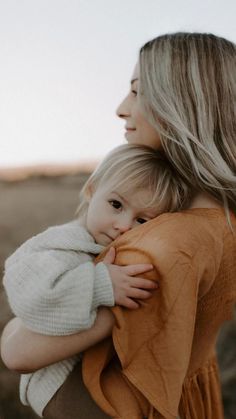 a woman holding a baby in her arms