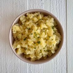 a bowl filled with mashed potatoes on top of a table