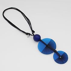 "Add flare to your outfit with this frosted lightweight resin pendant. Two blue round resin beads intricately wrapped in black thread are stacked together and hung from an adjustable black wax cord. Wear alone or with the coordinating earrings; the options are endless! Adjustable Length: 24\"-32\" Pendant: 6\" L x 2\" W Made to match: LS23E13 BLUE  Care Instructions: Remove jewelry when applying perfumes, creams, washing hands, etc. Do not store in direct sunlight. To restore color and shine, ap Blue Adjustable Long Necklace, Modern Blue Round Pendant Necklace, Blue Resin Round Pendant Necklace, Adjustable Resin Round Pendant Necklace, Blue Adjustable Lariat Long Necklace, Blue Round Pendant Necklace, Blue Necklaces With Adjustable Cord, Blue Necklace With Round Pendant, Adjustable, Adjustable Blue Round Pendant Necklace