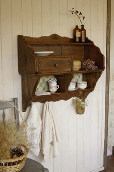 an old fashioned wooden shelf is hanging on the wall