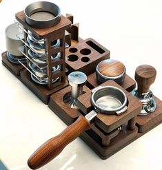 an assortment of kitchen utensils and pans on a wooden tray with a spoon