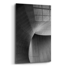 a black and white photo of a wall with an abstract structure in the middle,