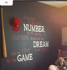 a child's bedroom with a baseball theme on the wall