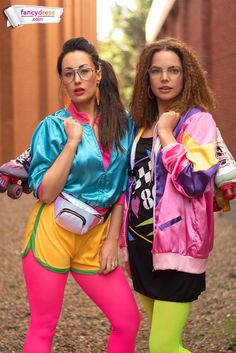 two women dressed in colorful clothing posing for the camera