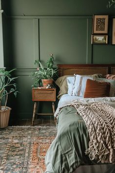 a bedroom with green walls and plants in the corner