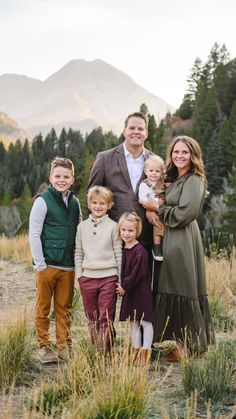 a family posing for a photo in the mountains