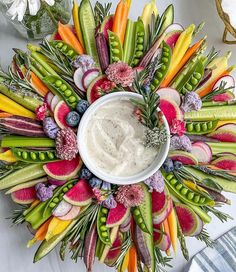 an arrangement of vegetables and dip in a bowl