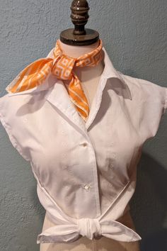 Wrapped blouse from a 1970's Butterick sewing pattern. Handmade by me. Sits at waist. Front buttoned closing, extended shoulders, elasticized front waist.  Measurements of the final garment are: 34 inch chest, 26 inch waist (will stretch)  18 inch length, Back waist 16 1/2 inch. Elastic is attached to the front sides. Elastic goes around waist in back, button blouse in front. Bring the tie ends to front and tie into knot. Scarf not included. Fitted Blouse 1970s Style For Summer, Fitted 1970s Style Summer Blouse, 1970s Style Fitted Cotton Blouse, Retro Style Fitted Blouse For Daywear, Retro Fitted Blouse For Daywear, Fitted Retro Blouse For Daywear, White Fitted Retro Blouse, Wrapped Blouse, Butterick Sewing Pattern