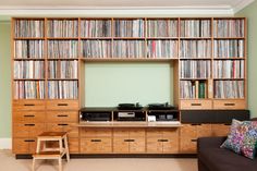 a living room filled with lots of furniture and bookshelves next to a tv