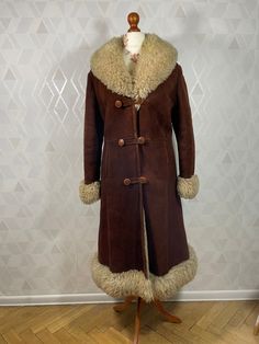 A unique dubble breasted coat made of thick sheepskin and neat thick leather in a dark brown color with a beige finish. This iconic Penny Lane coat is in very good condition, with normal sings of use, no damage, but remember that it is a wearable item. The coat is probably in size M, there is no tag. Dimensions: sleeve from the collar: 76 cm sleeve from armpit: 41 cm chest:49 x2 cm waist: 46 x 2 cm in the hips: 51 x2 cm total length: 114 cm In the territory of the European Union, we send parcels by GLS courier to other Global Express countries, if this service is available at the moment. You buy vintage items, each item has its own unique character which is related to its use. Things have traces of use, but we take care of the selection. Bohemian Leather Winter Outerwear, Bohemian Leather Outerwear For Winter, Bohemian Brown Outerwear With Faux Fur Lining, Bohemian Brown Fur Coat With Faux Fur Lining, Bohemian Long Fur Coat With Faux Fur Trim, Famous Hippies, Afghan Jacket, Penny Lane Coat, Penny Lane