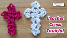 two crochet crosses sitting on top of a wooden table