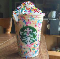 a starbucks drink with sprinkles and white frosting