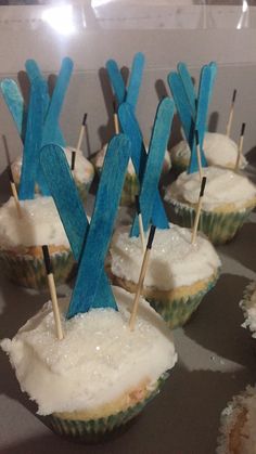 cupcakes with blue sticks sticking out of them