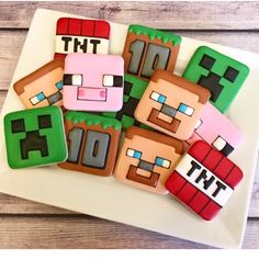 some cookies that have been decorated to look like minecraft characters are on a plate