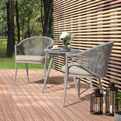 two chairs and a table on a wooden deck