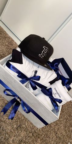 an open box with two hats and ties in it