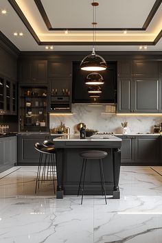 a kitchen with marble flooring and gray cabinetry, lights above the island counter