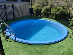 an above ground swimming pool with artificial grass