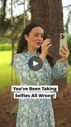 a woman taking a selfie with her phone in front of a tree and text that reads, you've been taking selfies all wrong