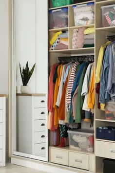 a white closet filled with lots of clothes