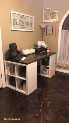 a computer desk sitting in the corner of a room