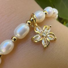 This is the perfect gift for any age! Our "Iki Momi" Freshwater Pearl Bracelets are adjustable! It's so easy to put on and take off because it can tighten to 5 inches and open up to 8 and 1/2 inches. The surprise is a sparkly charm with Cubic Zirconia. Pick from three designs, Pineapple, Turtle or Plumeria Flower. At this great price, be sure to get one for yourself! Great for all ages and fits just about anyone. Gold or Silver accents with white pearls. Mix and match. Pick: White Pearls Gold or White Resizable Pearl Bracelet For Gift, White Resizable Pearl Bracelet Gift, Adjustable Gold Pearl Flower Bracelet, Hawaiian Pearl Jewelry, Pearl White Adjustable Pearl Charm Bracelet, Hawaiian Pearl Necklace, Pearl Bracelet Stack, Hawaiian Necklace Pearl, Adjustable Hand-strung Pearl White Pearl Bracelet