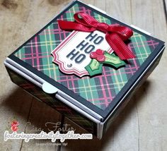 a close up of a box on a wooden floor with a ribbon around the top