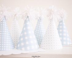 four blue and white party hats on a shelf