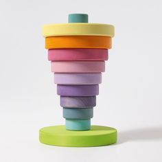 a stack of colorful wooden toys sitting on top of a table