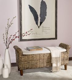 a wicker bench in front of a painting and vases