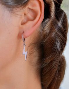 If you're looking for a gift that's sure to make a statement, our lightning bolt earrings are the perfect choice. These stunning drops will add a little sass to any outfit--whether you're dressing up or down. And with their dainty size and lightweight design, they'll never be anything but comfortable. Our lightning bolt earrings come in either silver or gold. So whether you want to add a little bling or make a bold statement by wearing them with your favorite black outfit, we've got you covered! Bolt Earrings, Lightning Bolt Earrings, Heart Hoop Earrings, Silver Drop Earrings, Lightning Bolt, Silver Hoop Earrings, Black Outfit, Elegant Woman, Silver Color