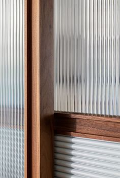 an open window with blinds on the outside and wood trim around the windowsills