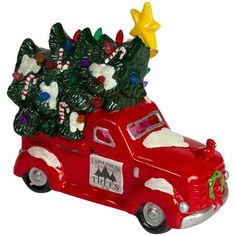 a red truck with christmas trees in the back and stars on it's roof