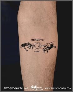 a man's arm with tattoos on it that says, mementoo mori