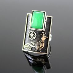 Silver ring with Armenian infinity sign and peacock pattern. The shape is classic, rectangular. She grabs finger very nicely. At the top of the ring is natural chrysolite. The ring is quite large with an interesting design.The ornament is copied from ancient Armenian national drawings.Author's handwork.Ring size - 3,5*2 cm.Ring weight - 10 g. Modernist Rectangular Jewelry For Anniversary, Art Deco Rings With Rectangular Stone For Gift, Art Deco Ring With Rectangular Stone For Gift, Hallmarked Rectangular Emerald Ring, Vintage Rectangular Emerald Ring Gift, Modernist Green Jewelry For Gifts, Modernist Green Ring As A Gift, Green Modernist Ring As A Gift, Modernist Green Ring For Gift