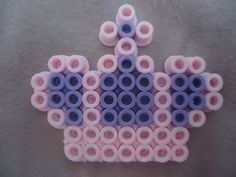 several pink and blue objects are arranged in the shape of a crown on a gray surface