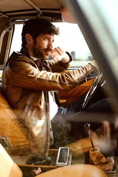 a man sitting in the passenger seat of a car