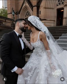 the bride and groom are posing for pictures on their wedding day in front of an old church