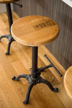 two wooden stools sitting on top of a hard wood floor next to each other