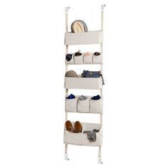 a white shoe rack with four pairs of shoes on top of it and two bags in the bottom