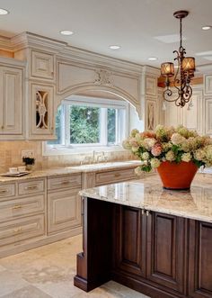 a large kitchen with marble counter tops and wooden cabinets