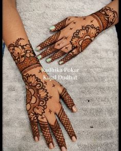 two hands with henna tattoos on them