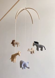 an animal mobile is hanging from the ceiling