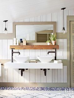 a bathroom with two sinks and a mirror on the wall next to a door that leads to another room