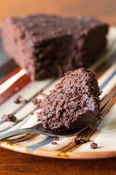 a piece of chocolate cake on a plate with a fork