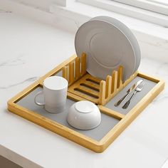 a tray with plates, cups and spoons on it