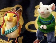 two figurines of mice wearing sweaters and hats